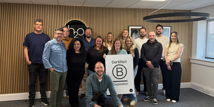 An Image of our team holding B Corp certified sign