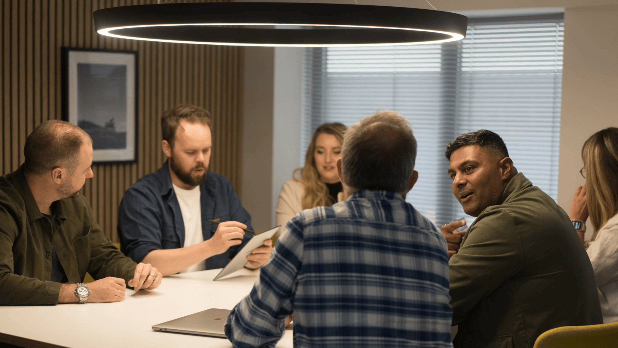 Our staff members around a desk collaborating