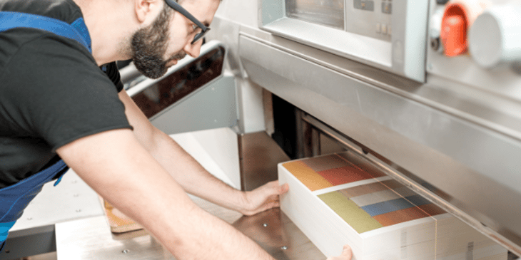 showing print materials coming out of the printer