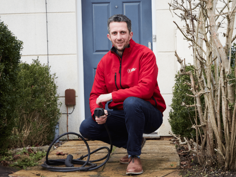 Kerbo Charge Co-founder walking over electric charging cable