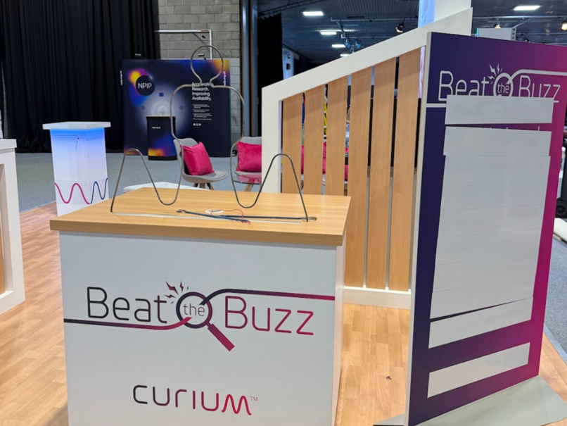 An image showing the stand we designed, with the beat the buzz game
